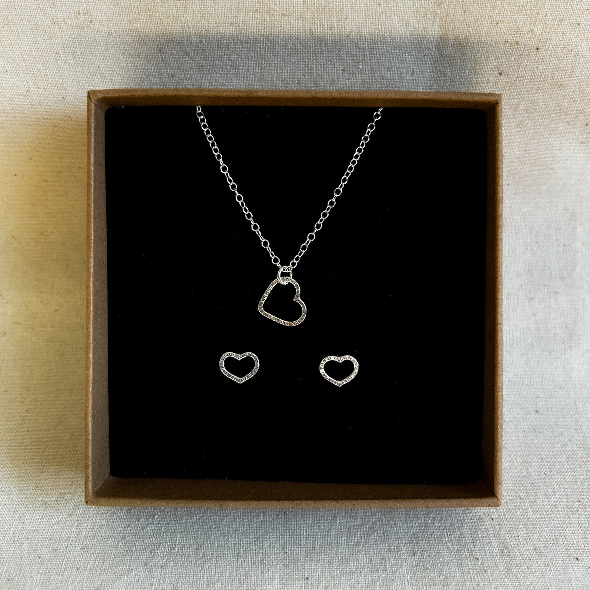 Heart shaped earring and pendant gift set displayed in a recycled jewellery box.