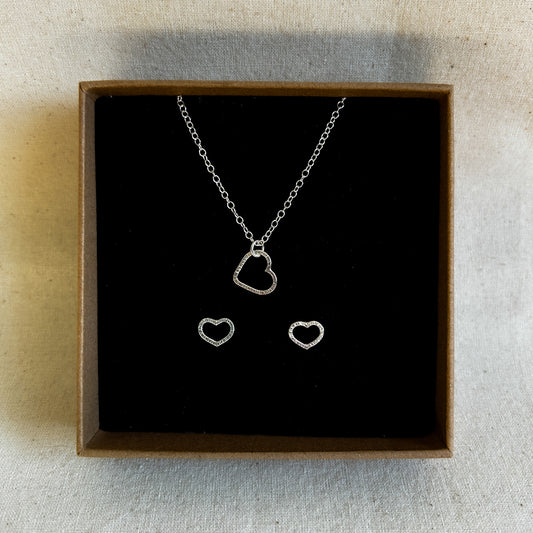Heart shaped earring and pendant gift set displayed in a recycled jewellery box.