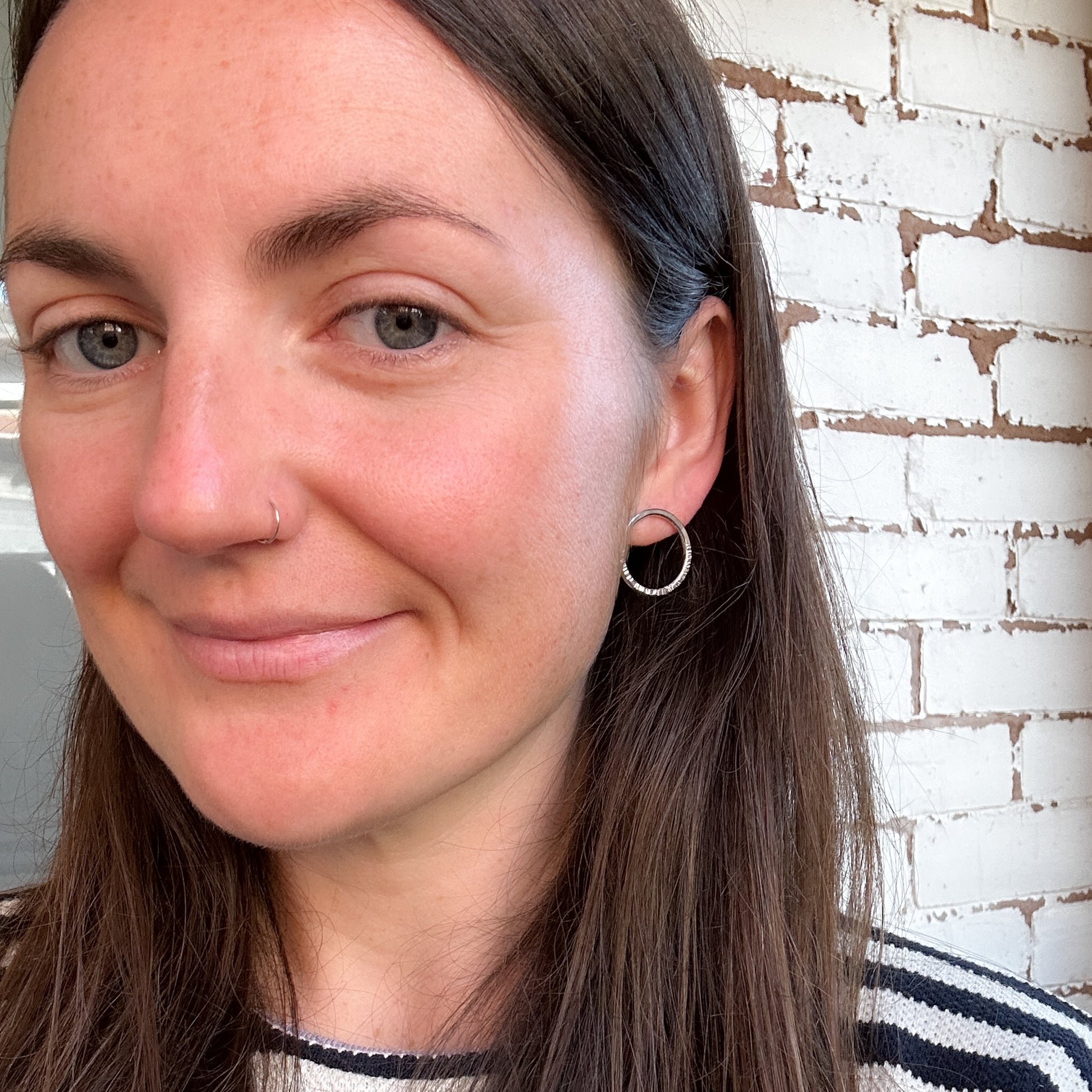 Model wearing Argentium earrings with hoop design