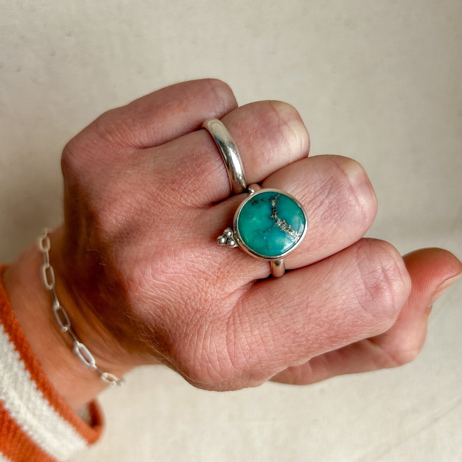 Boho turquoise ring seen on clenched fist