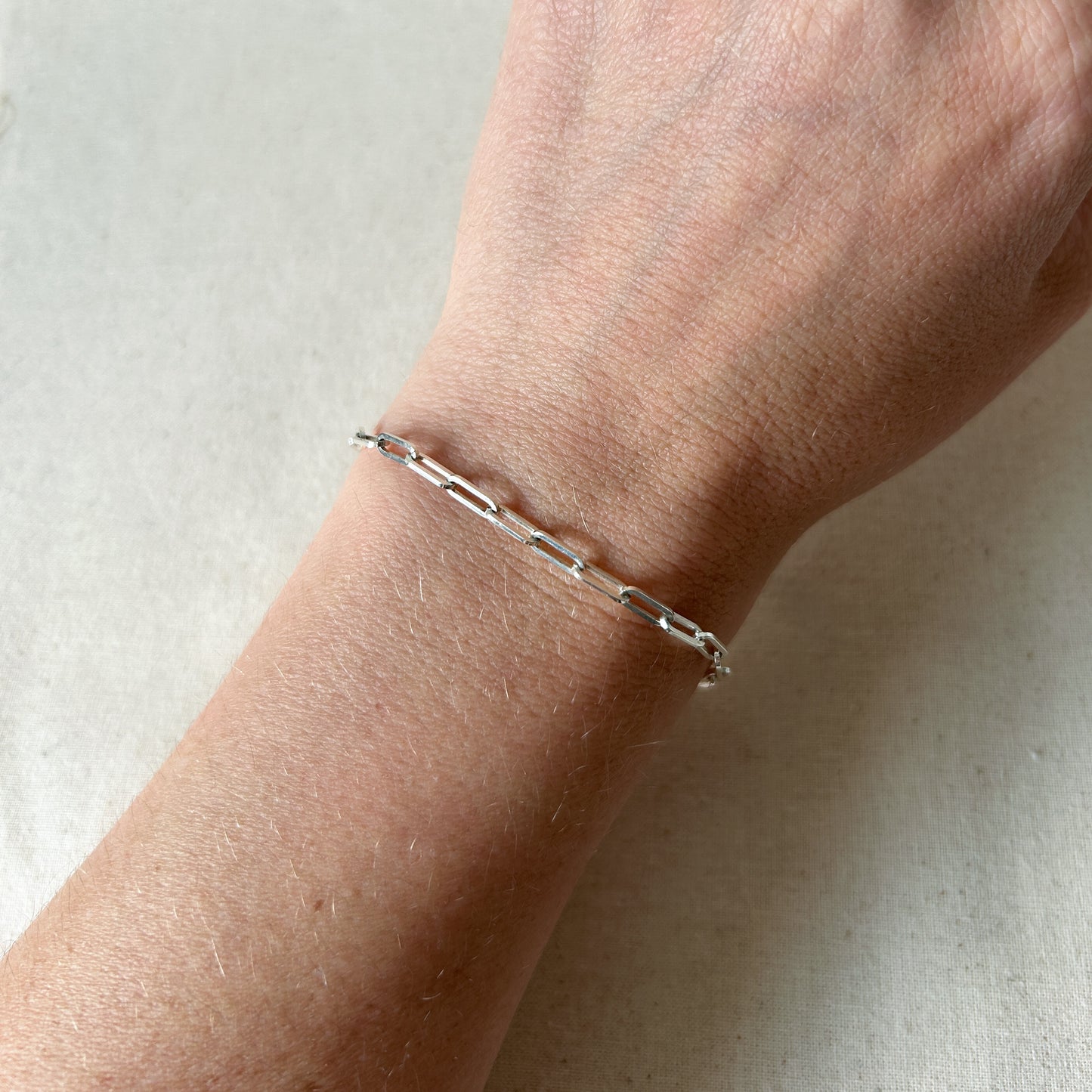 Silver paperclip bracelet on wrist