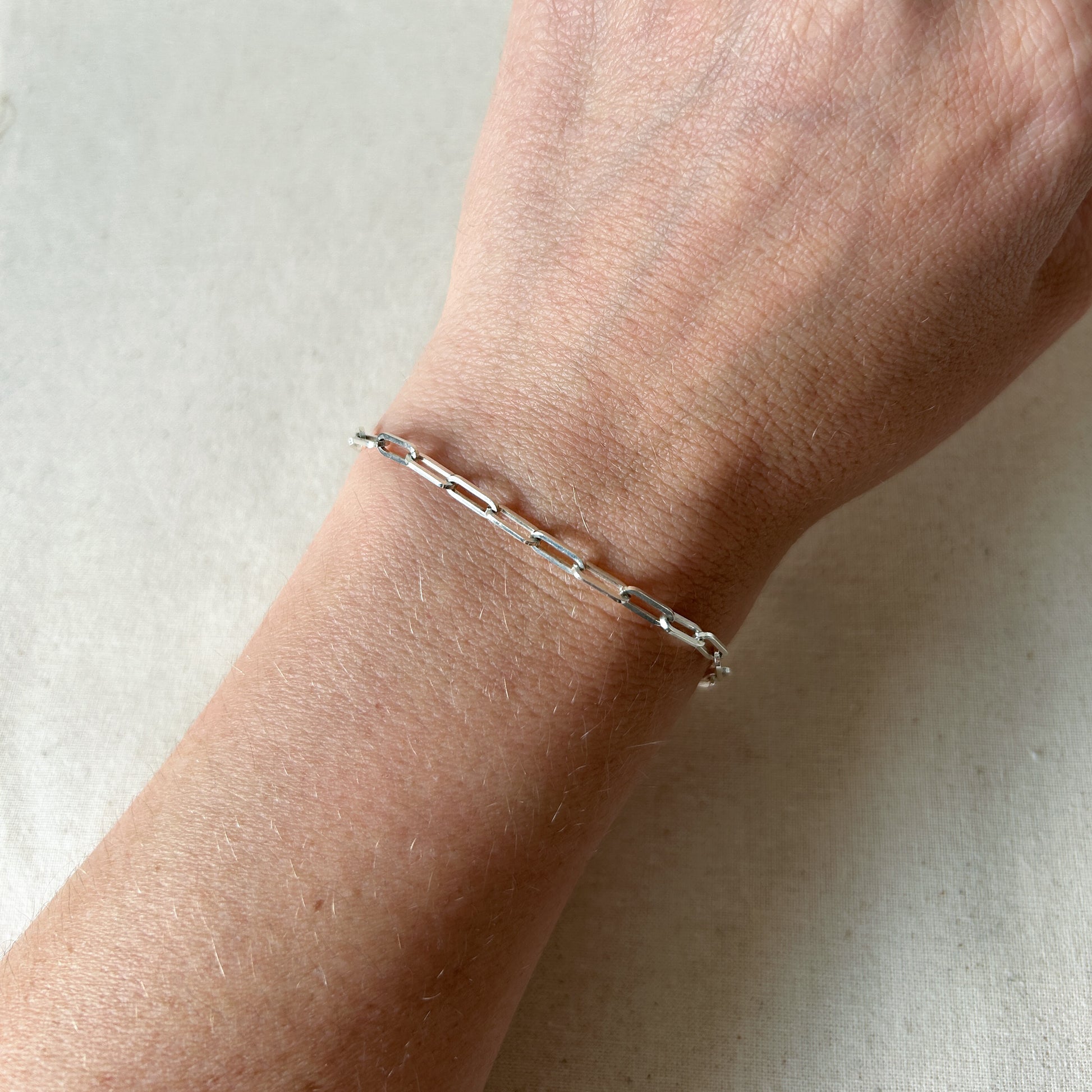 Silver paperclip bracelet on wrist