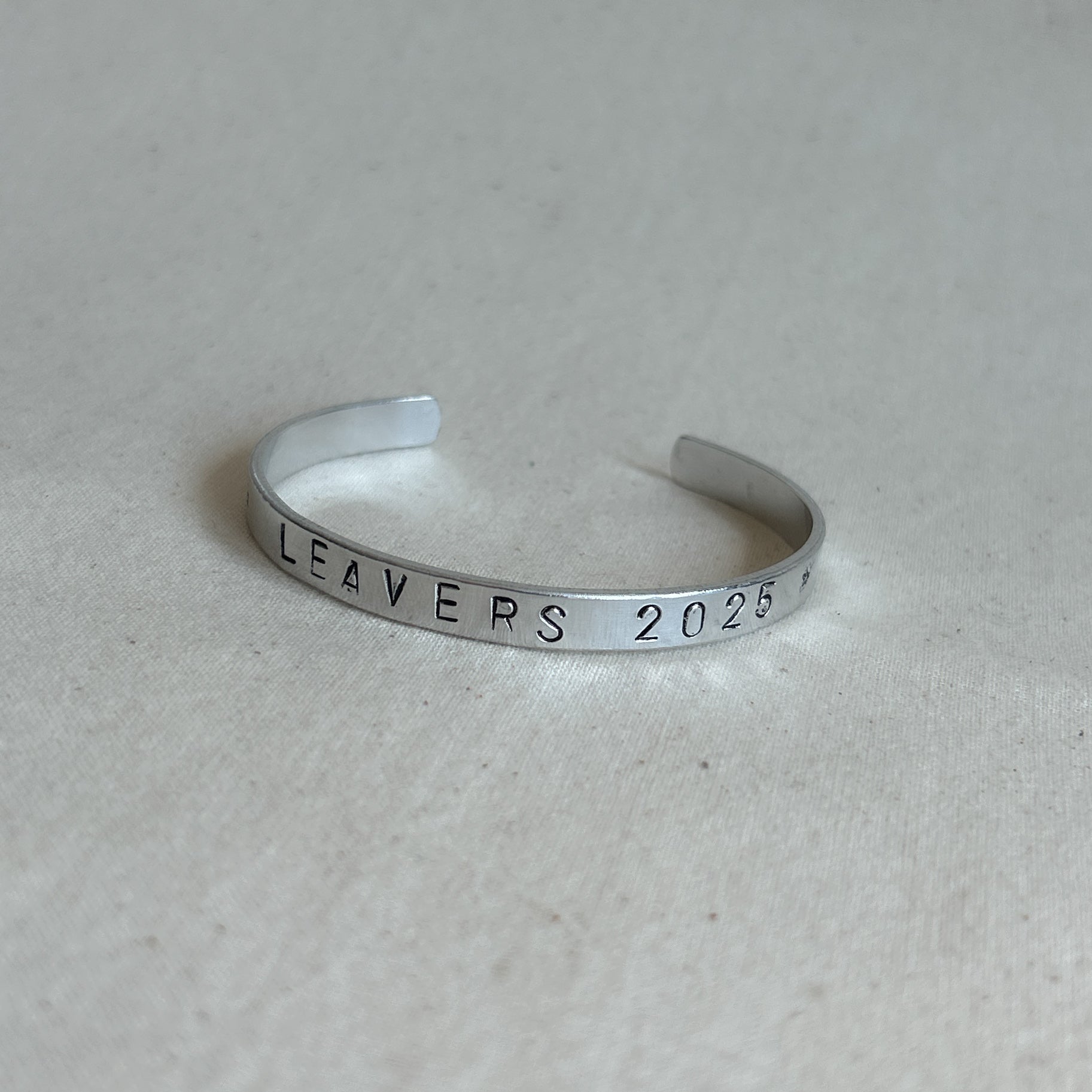 Bracelet with “leavers 202” stamped
