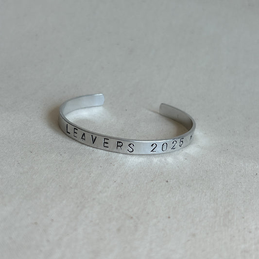 Bracelet with “leavers 202” stamped