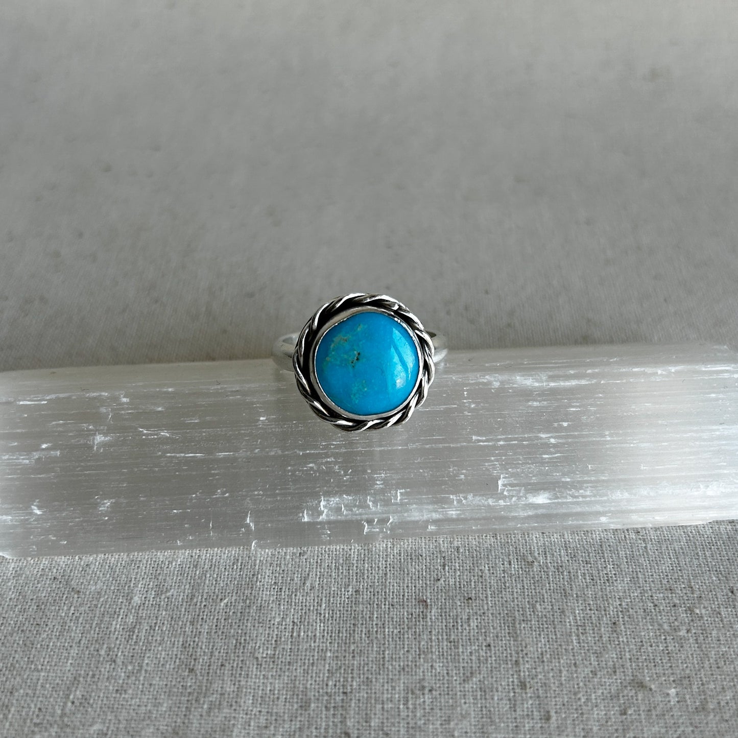 Turquoise ring on grey background