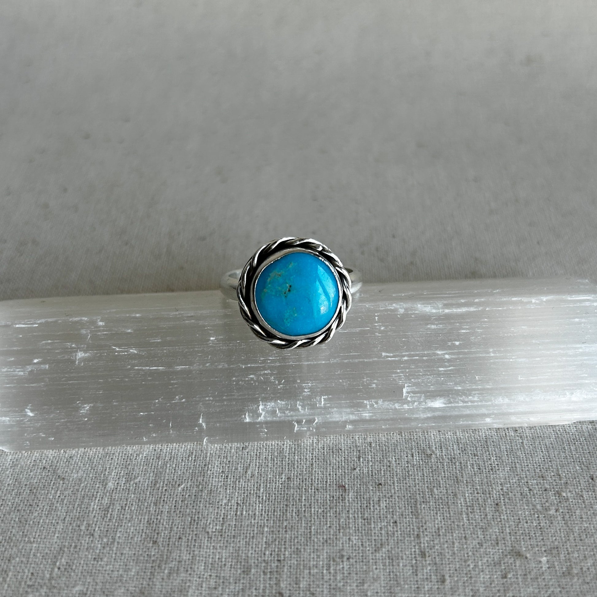 Turquoise ring on grey background