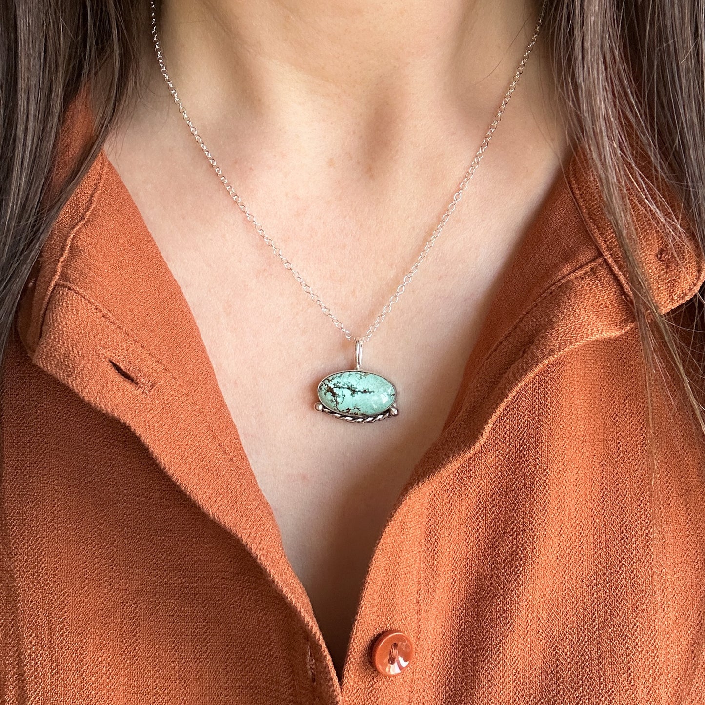 Southwestern turquoise pendant with silver chain worn by model