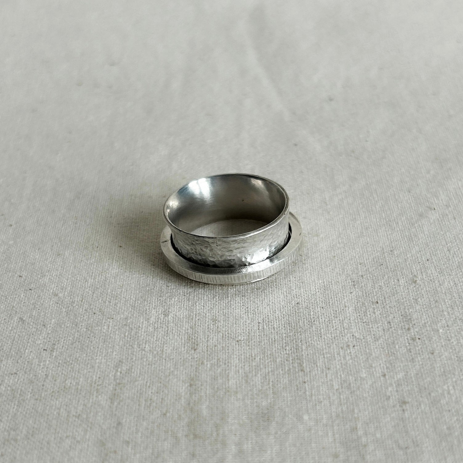 Silver ring on a textured gray background