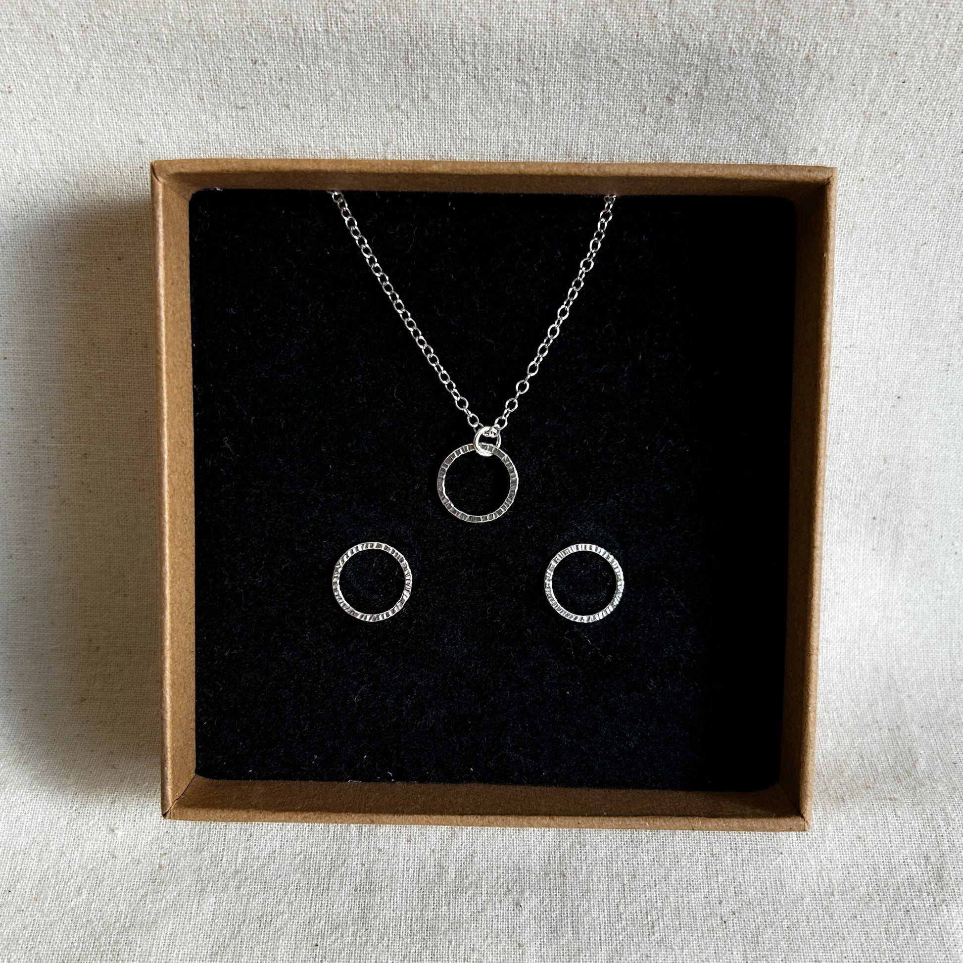 Gift set containing silver bubble earrings and matching pendant displayed in a recycled jewellery box.
