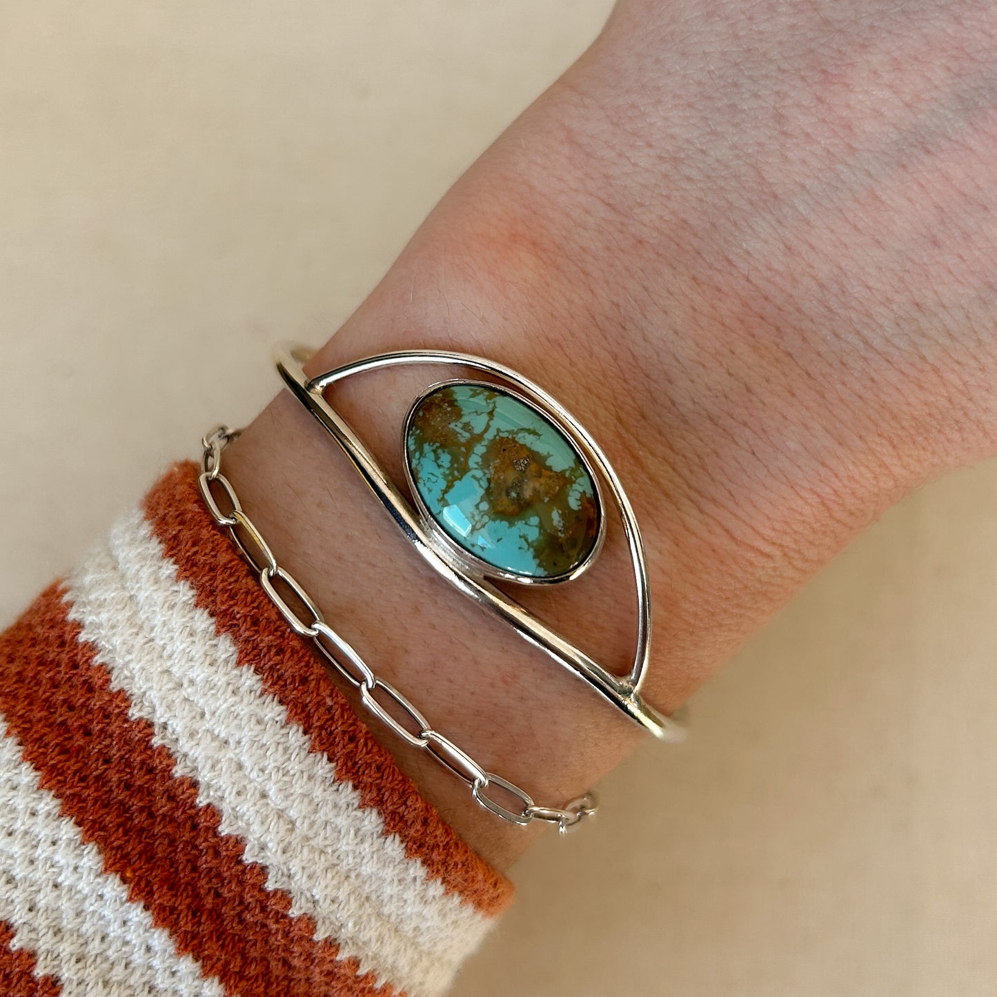 Large turquoise cuff modeled on wrist