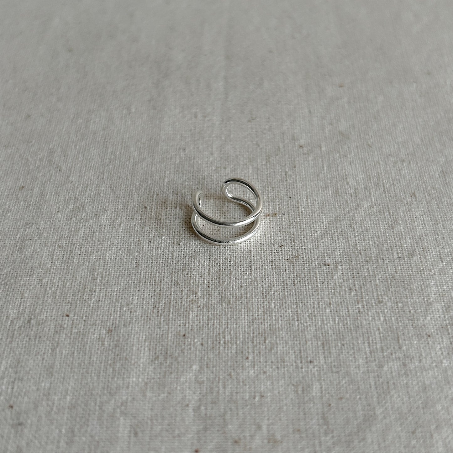 Side view of minimalist silver ear cuff made from Argentium silver