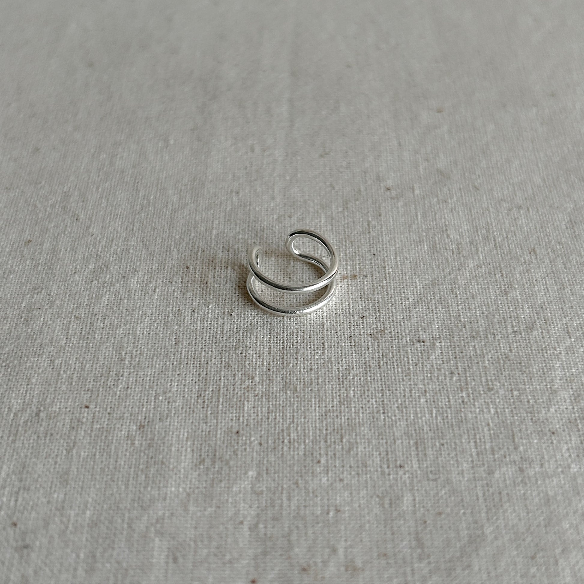 Side view of minimalist silver ear cuff made from Argentium silver