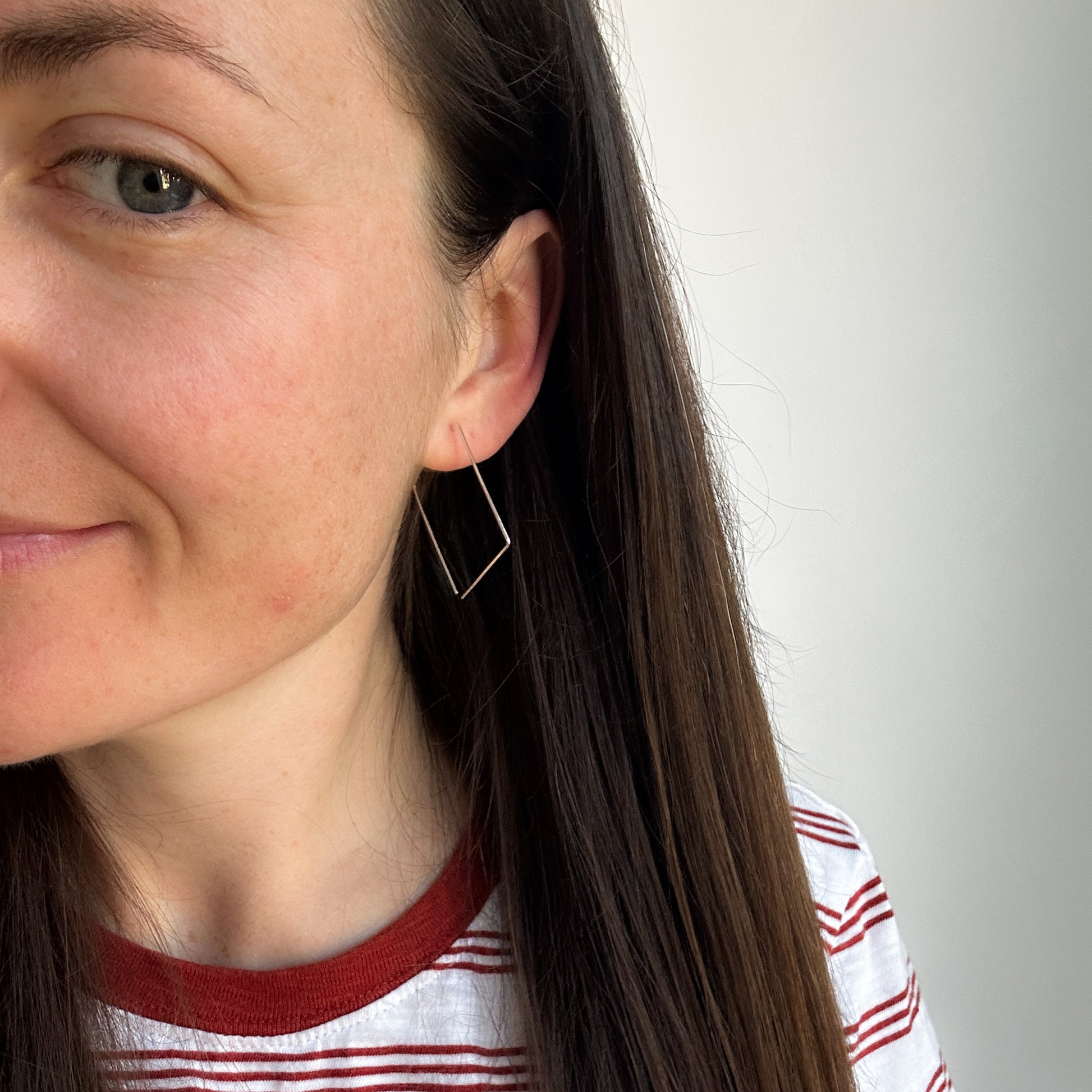 Model wearing square Argentium earrings