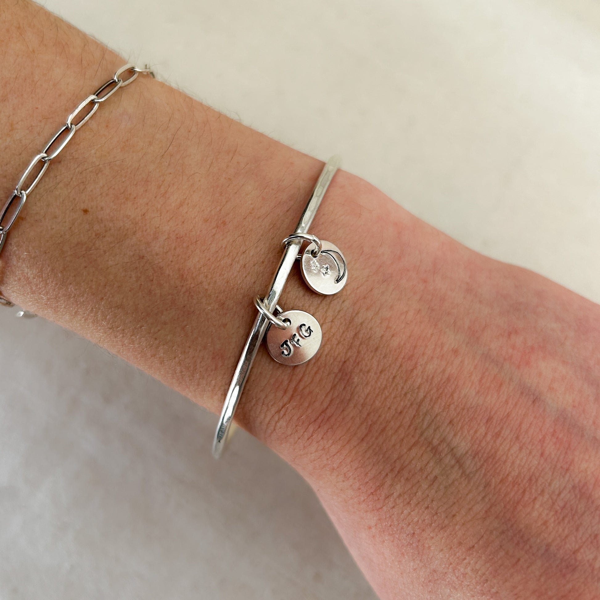 Sterling silver bangle with round dangly charms