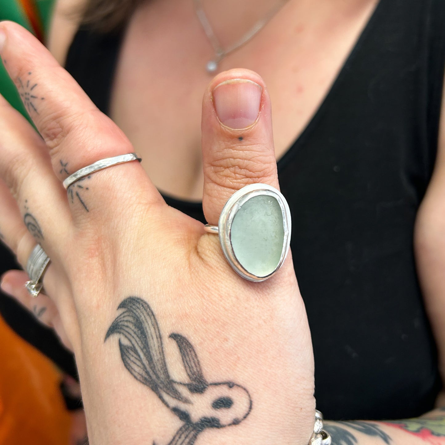 Student showing seaglass ring from workshop