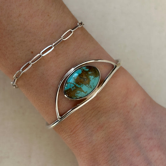 Large turquoise gemstone set in minimalist silver design cuff bracelet
