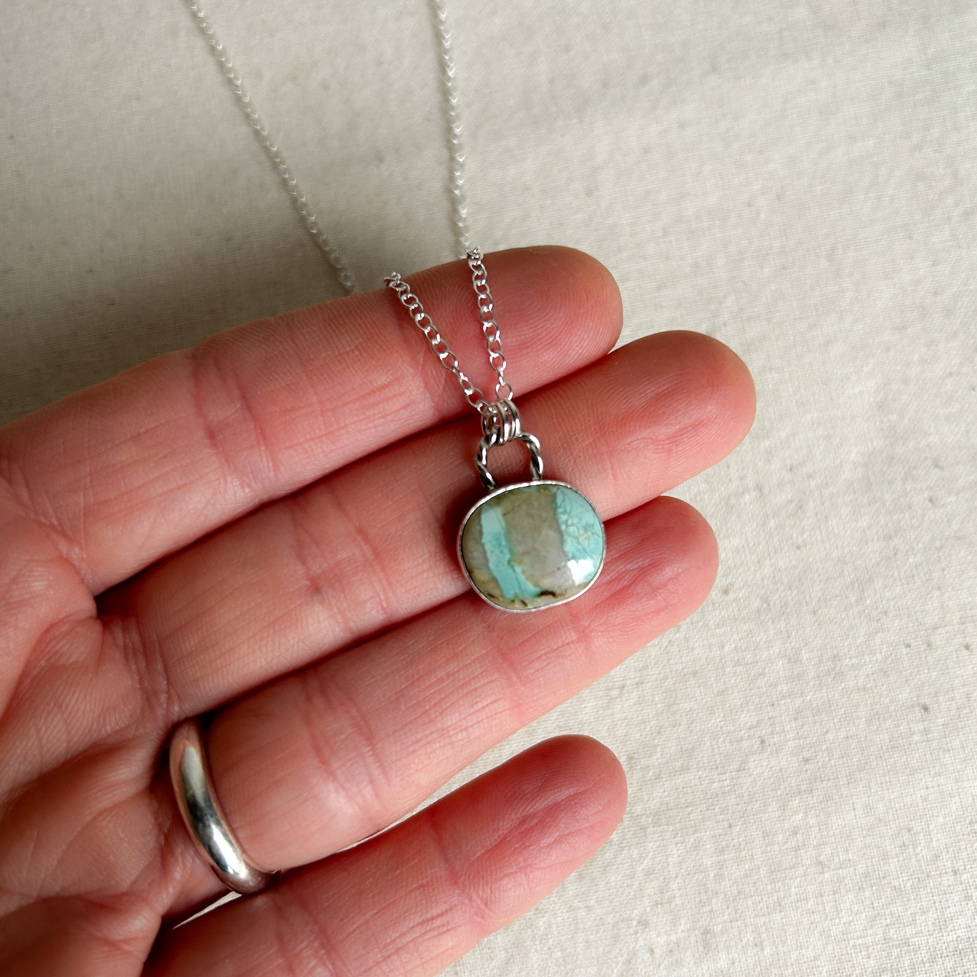Small turquoise pendant necklace with rope-style bail