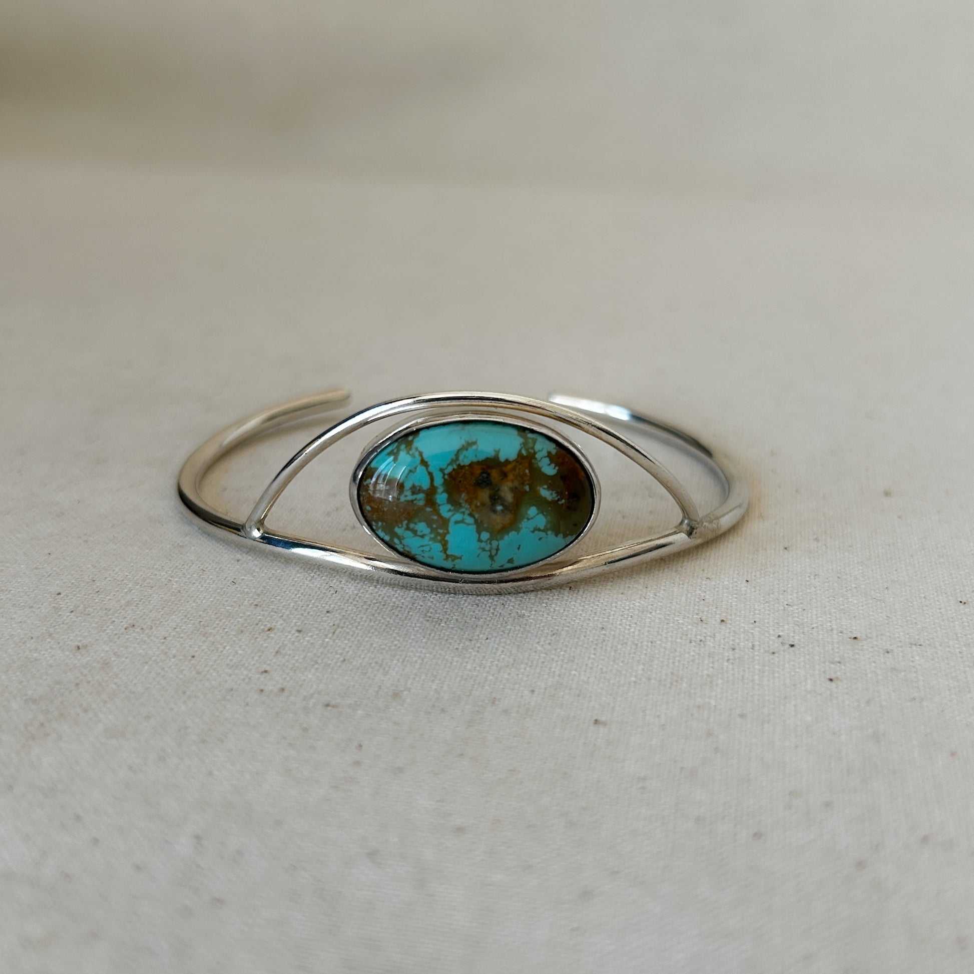 Large turquoise gemstone in silver setting.