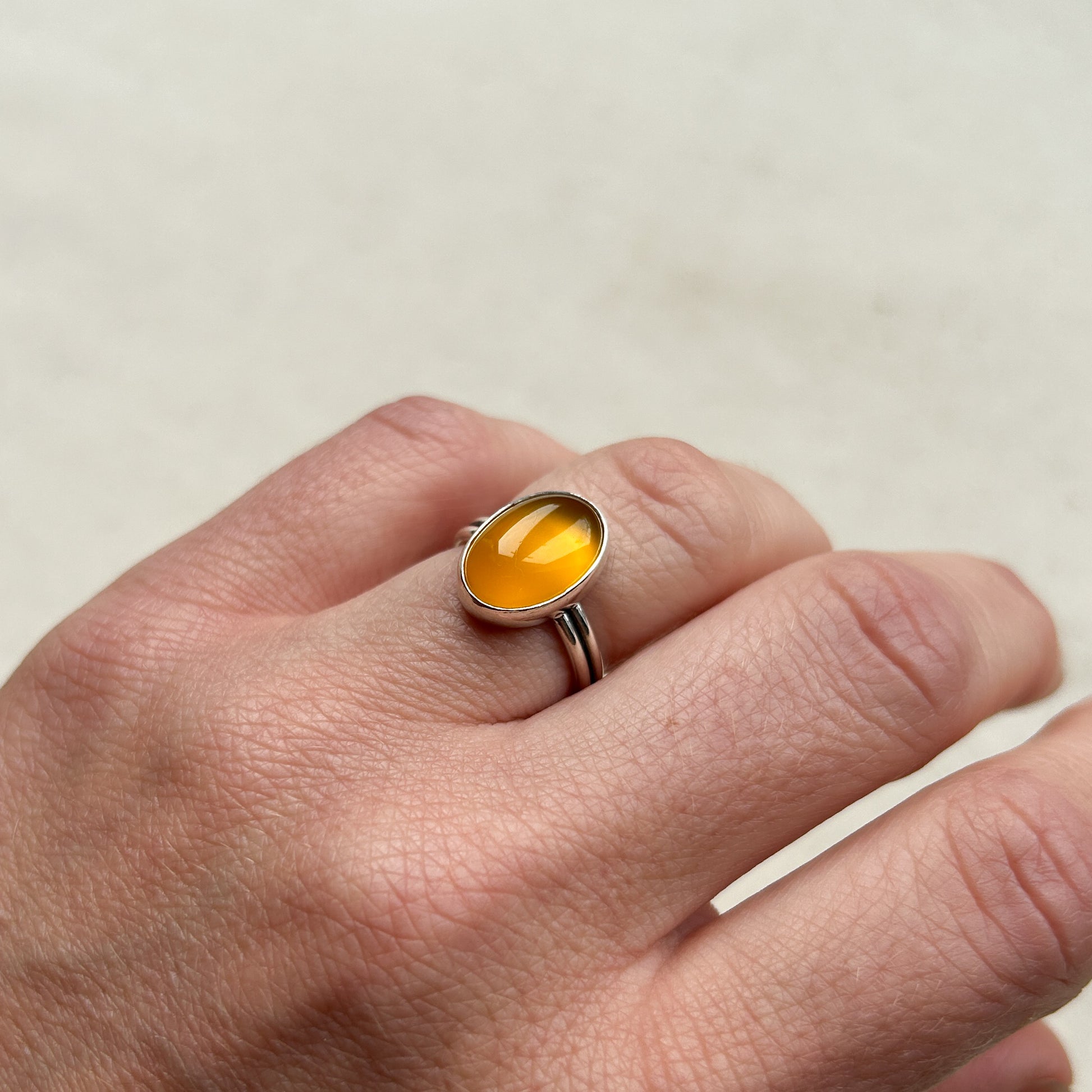 Yellow chalcedony ring on model's hand