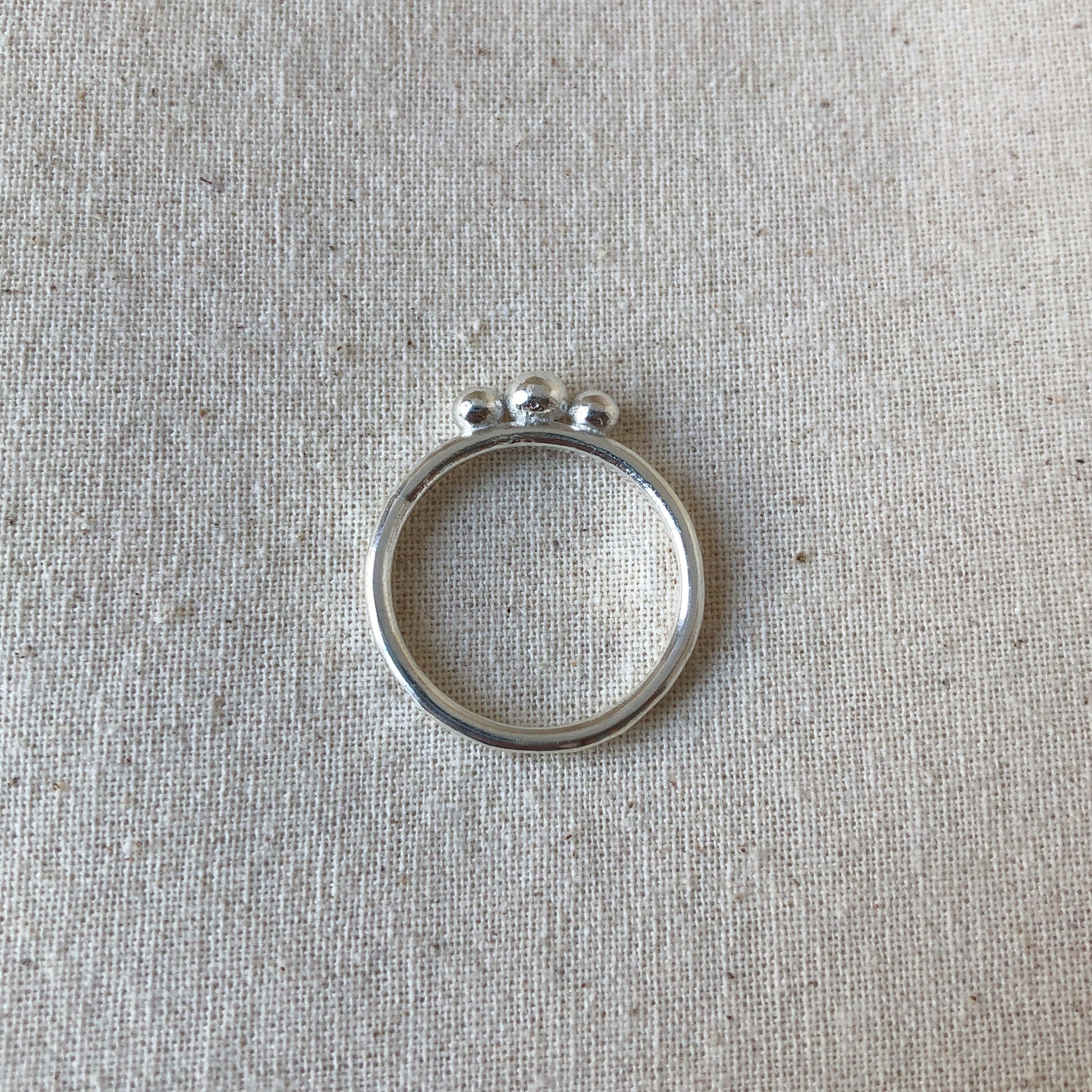Silver ball ring with on grey background