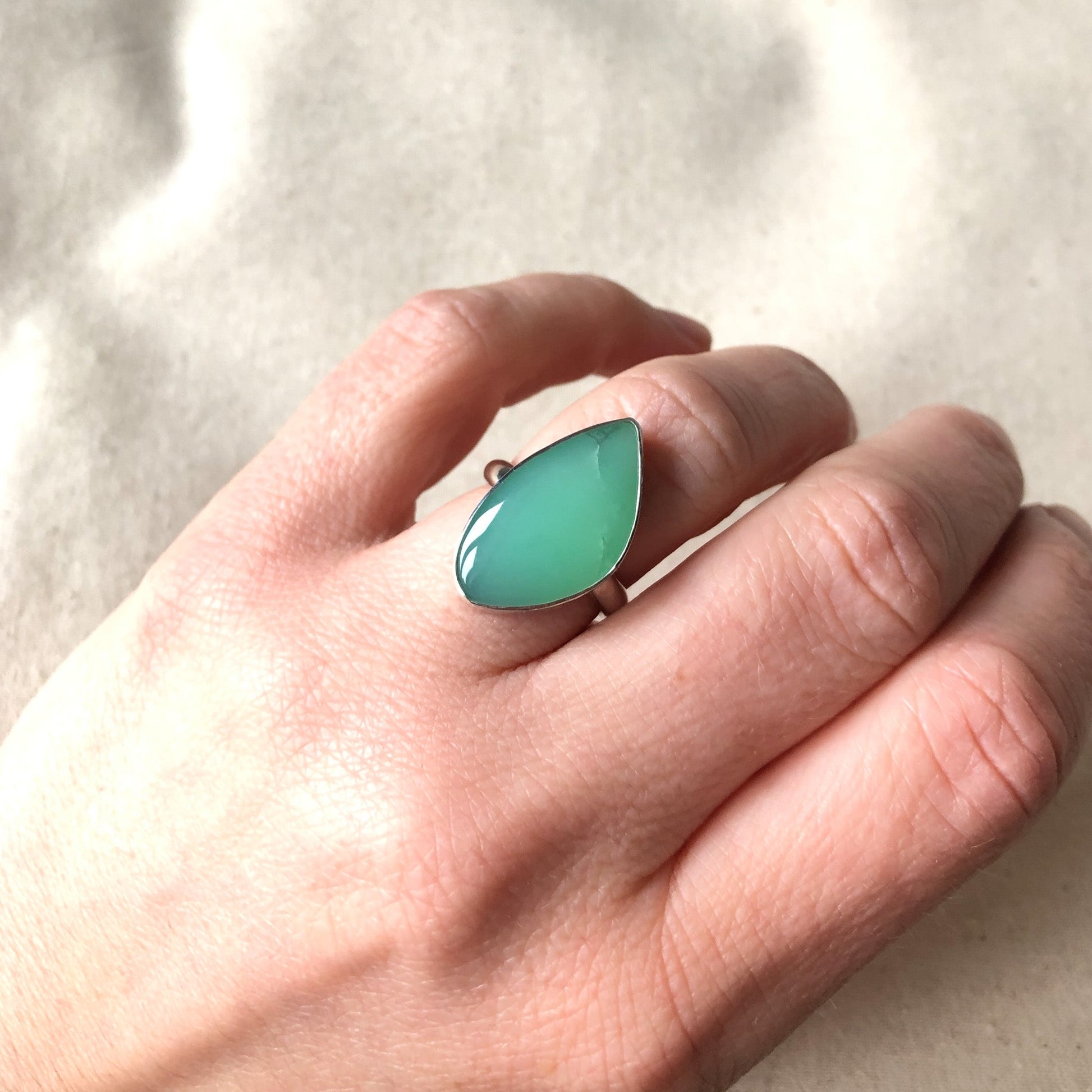 Model wearing handmade statement ring with chrysoprase gemstone
