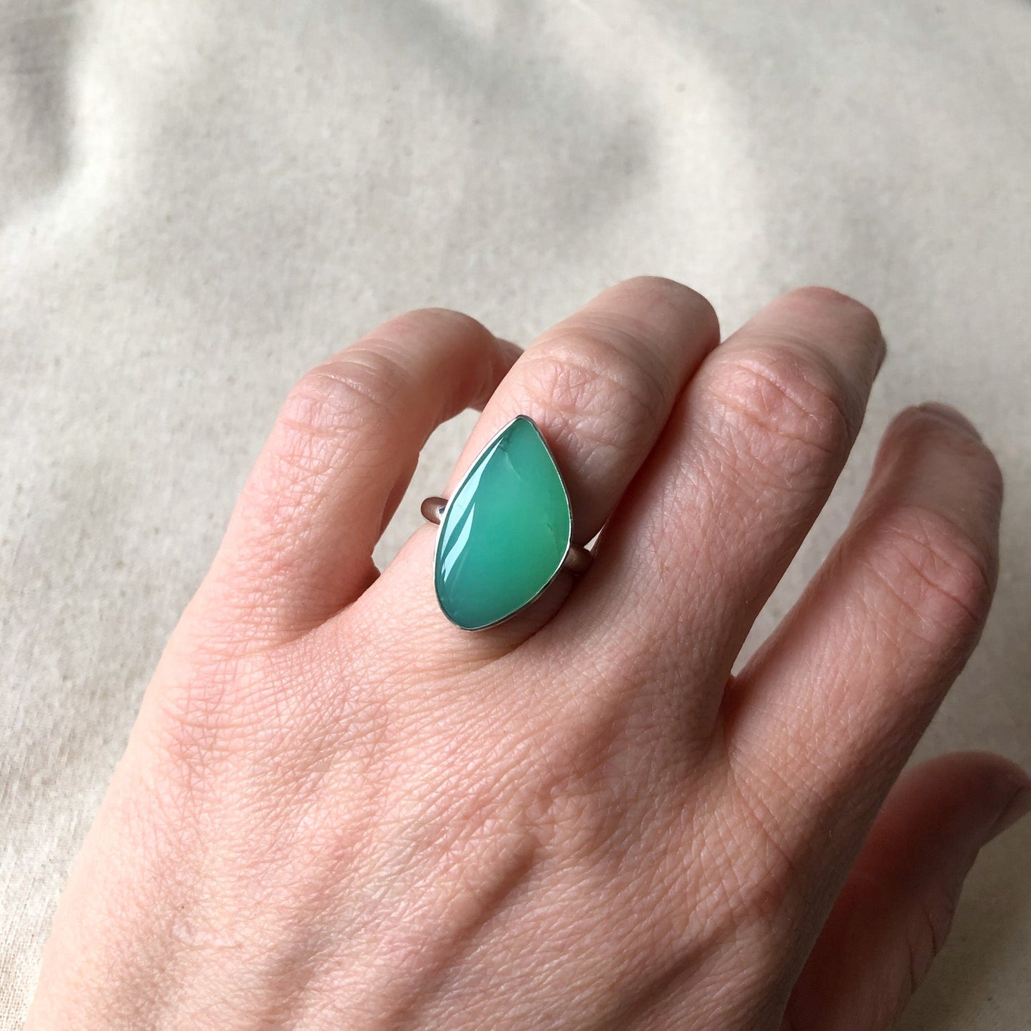Model wearing a gemstone statement ring made with Chrysoprase gemstone