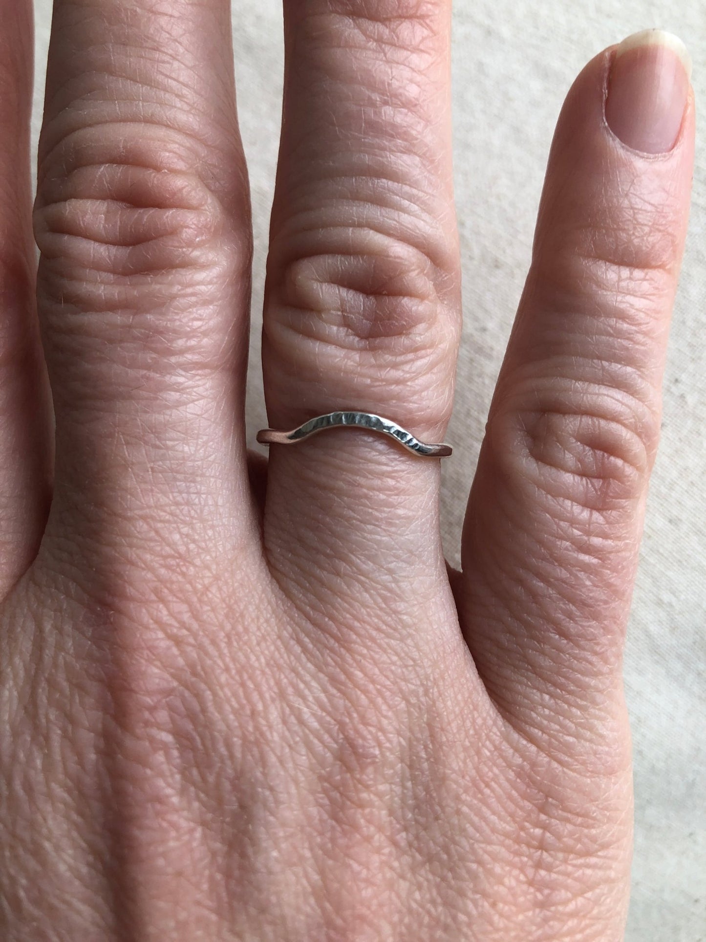 Shimmer sterling silver curved stacking ring on model's hand