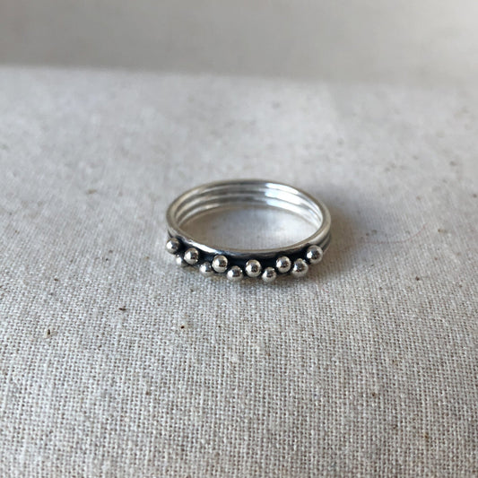 Triple band ring on grey background
