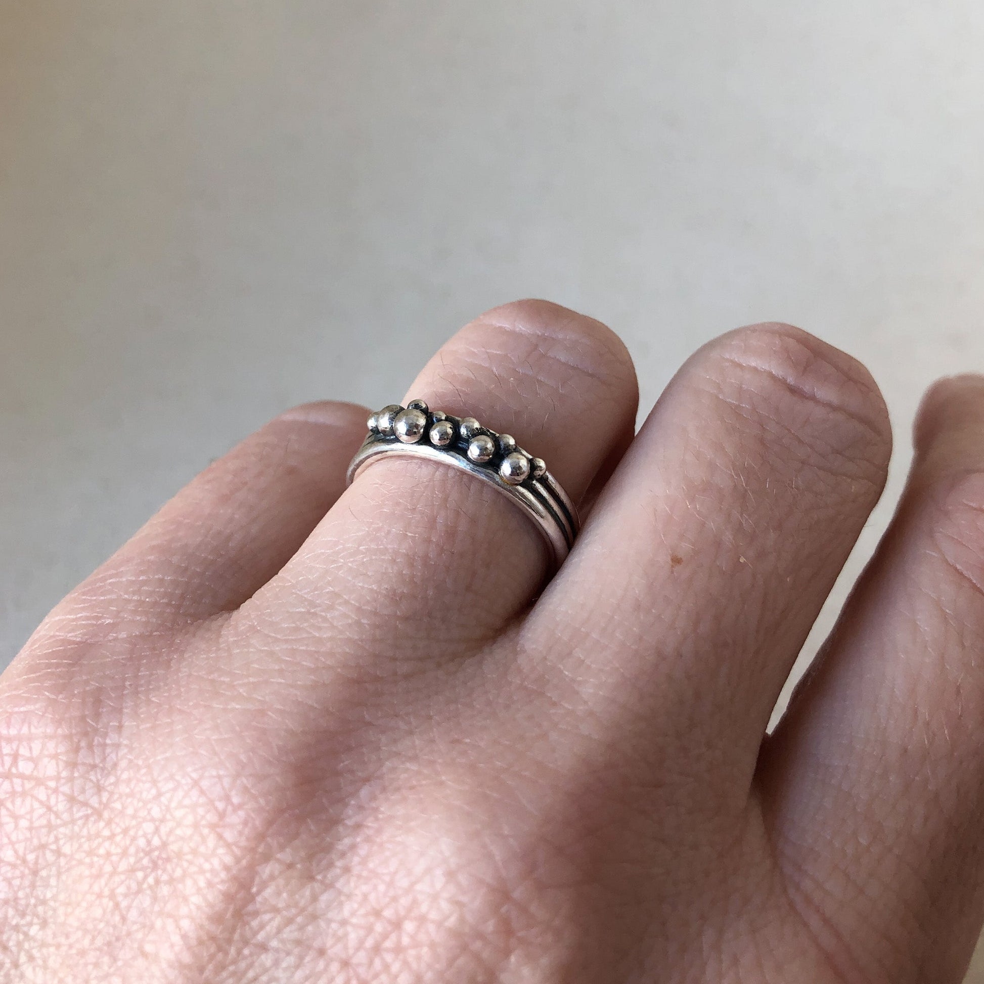 Model's hand with simple silver ring
