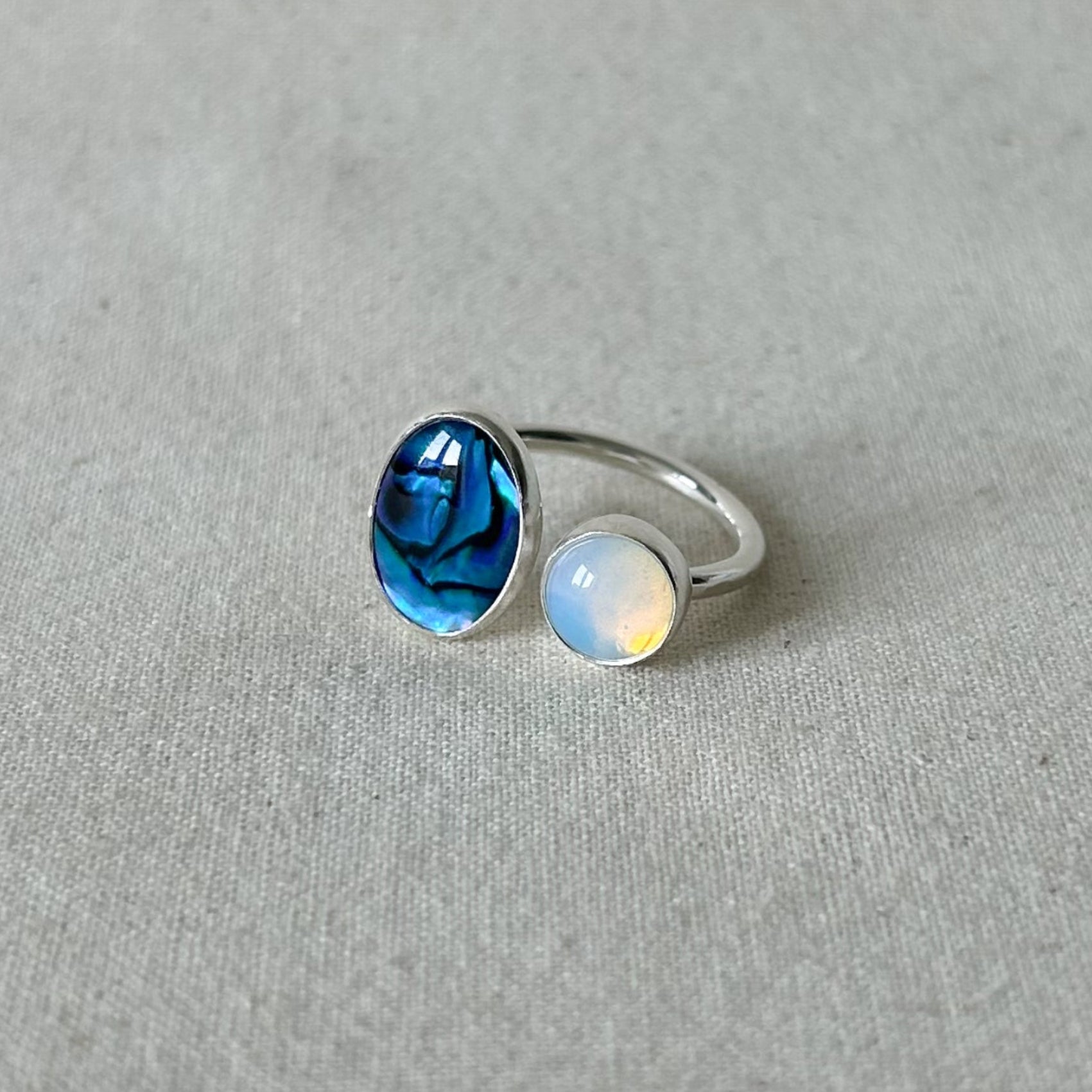 Blue oval gemstone ring on gray background 