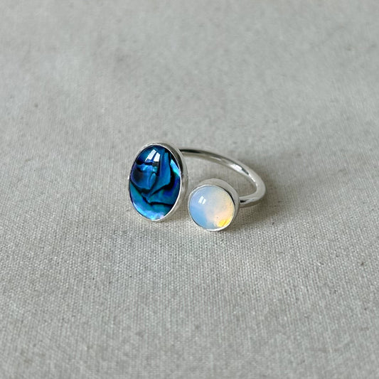 Blue oval gemstone ring on gray background 