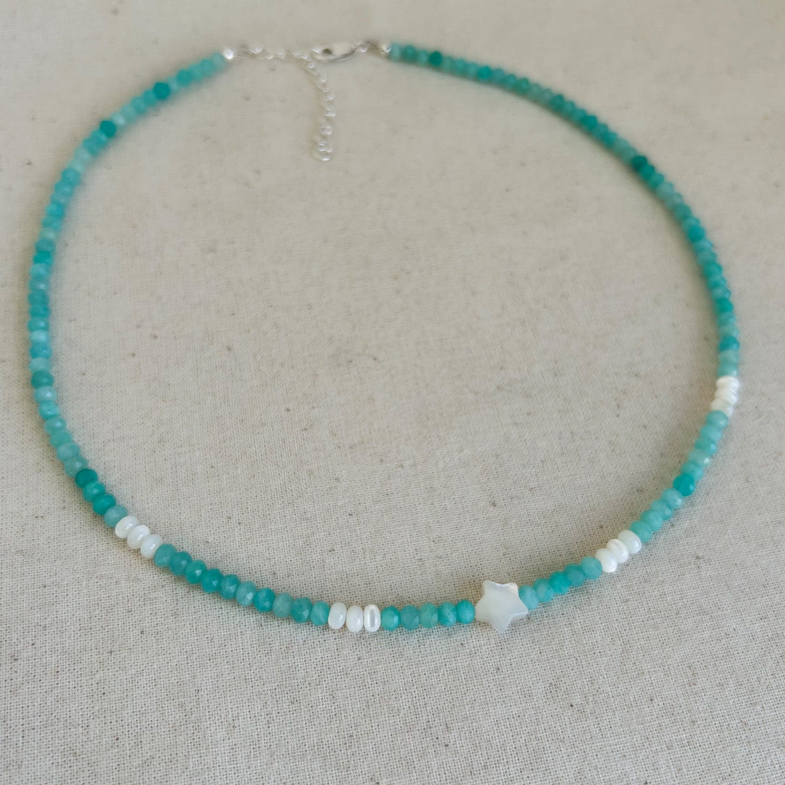 Necklace with turquoise beads on a neutral background