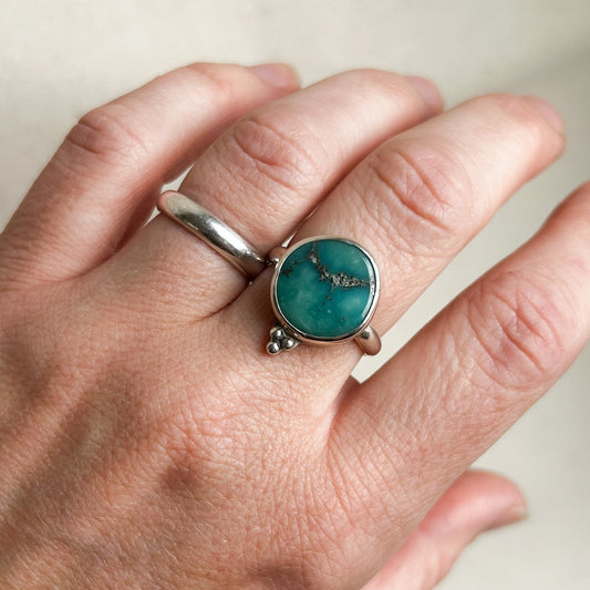 Boho turquoise ring on middle finger 