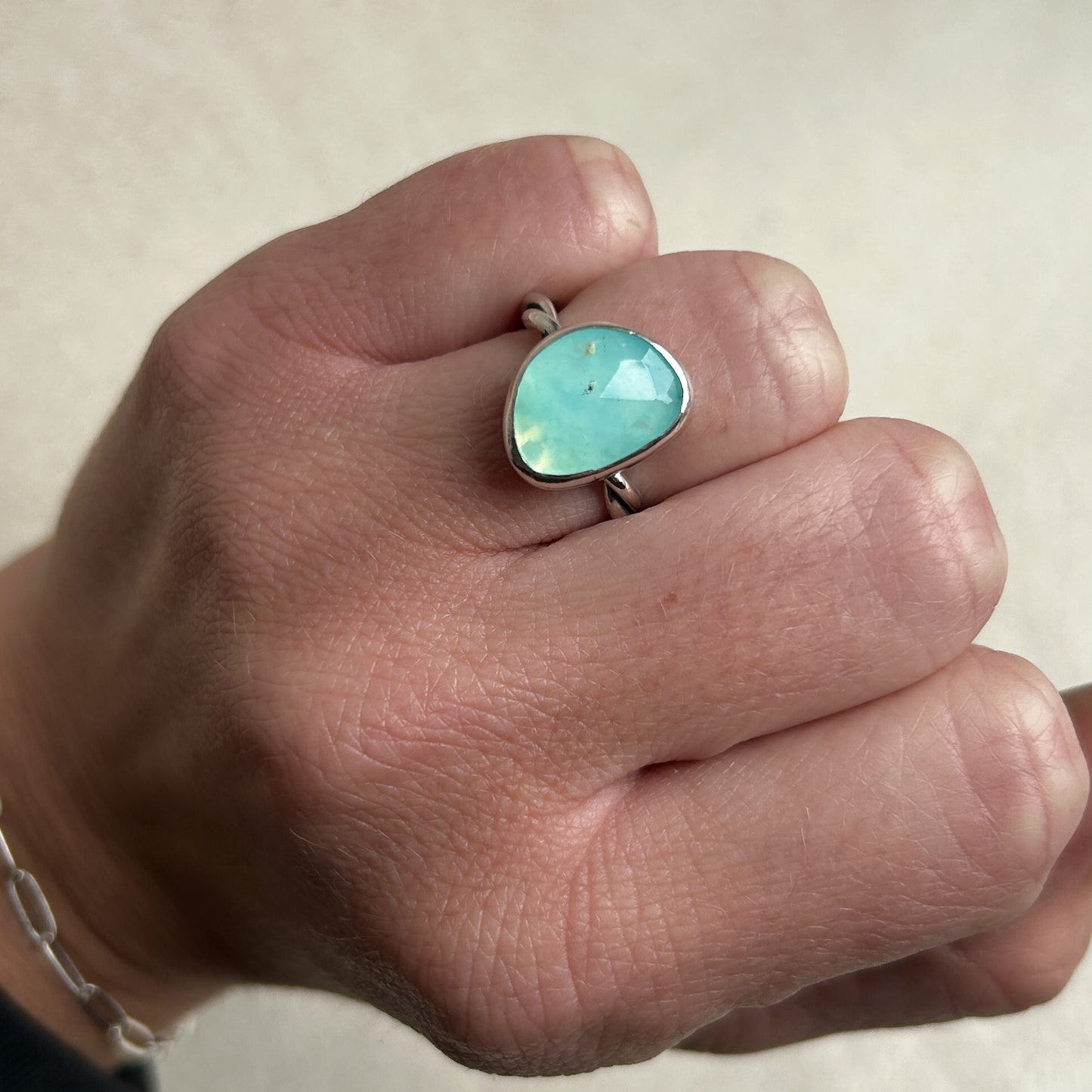 Pale blue Opal ring being work on wedding finger 