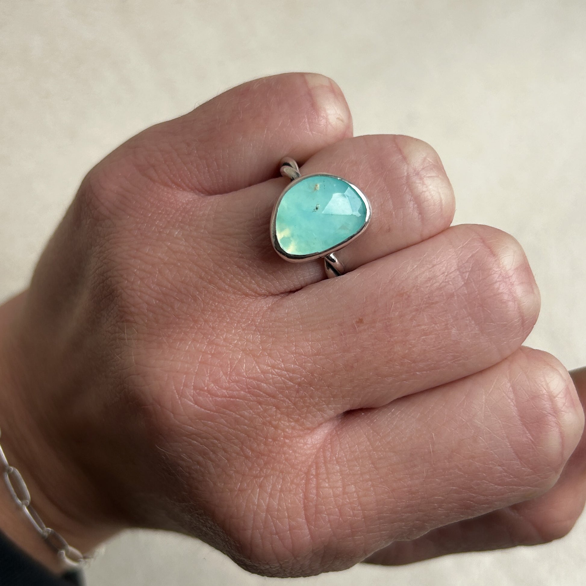 Pale blue Opal ring being work on wedding finger 