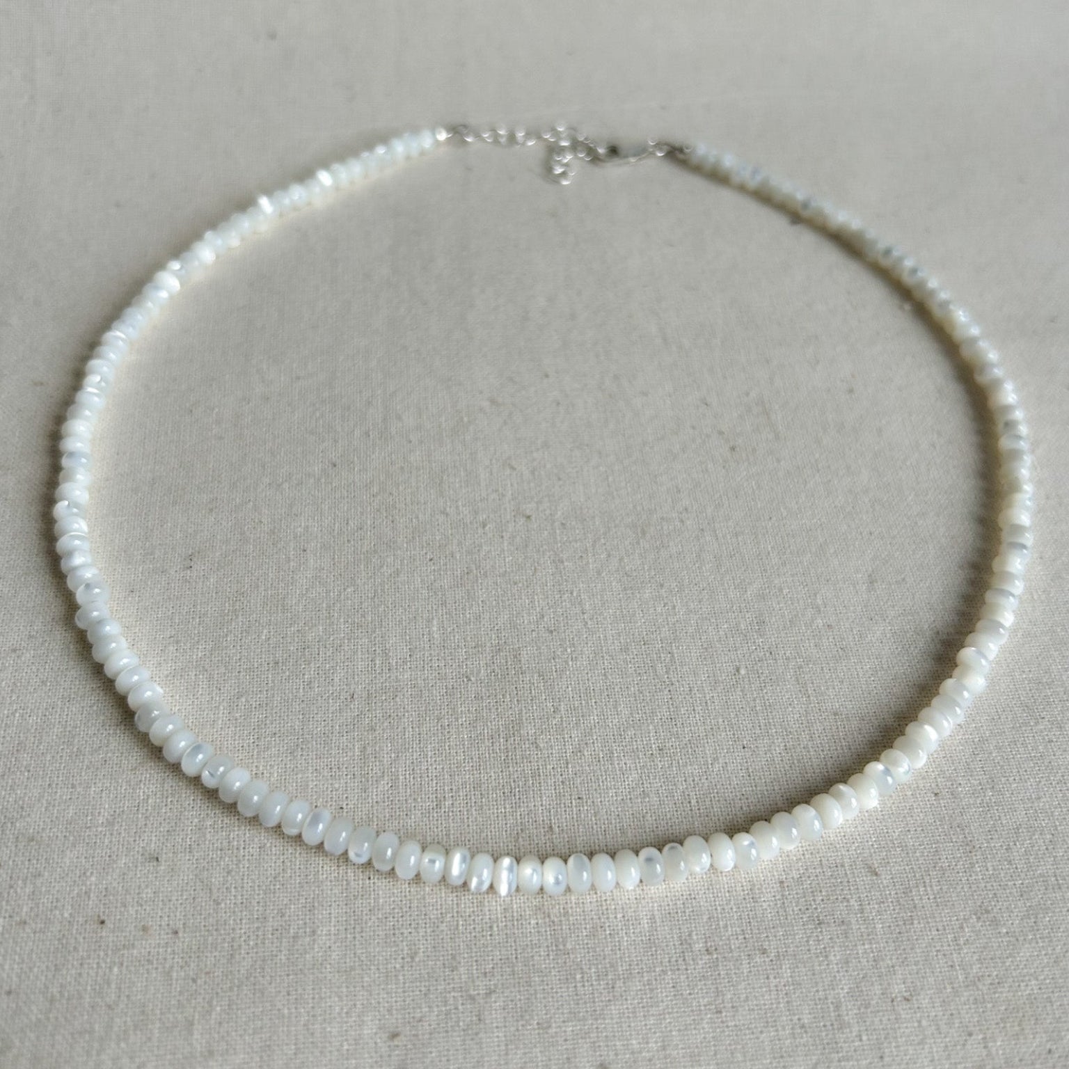 Pearl necklace on a light gray background