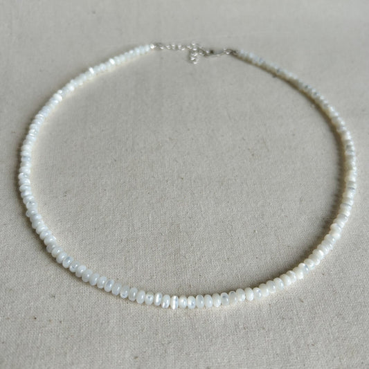 Pearl necklace on a light gray background