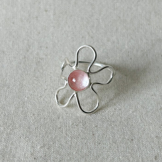 Light pink gemstone flower ring on a gray background 