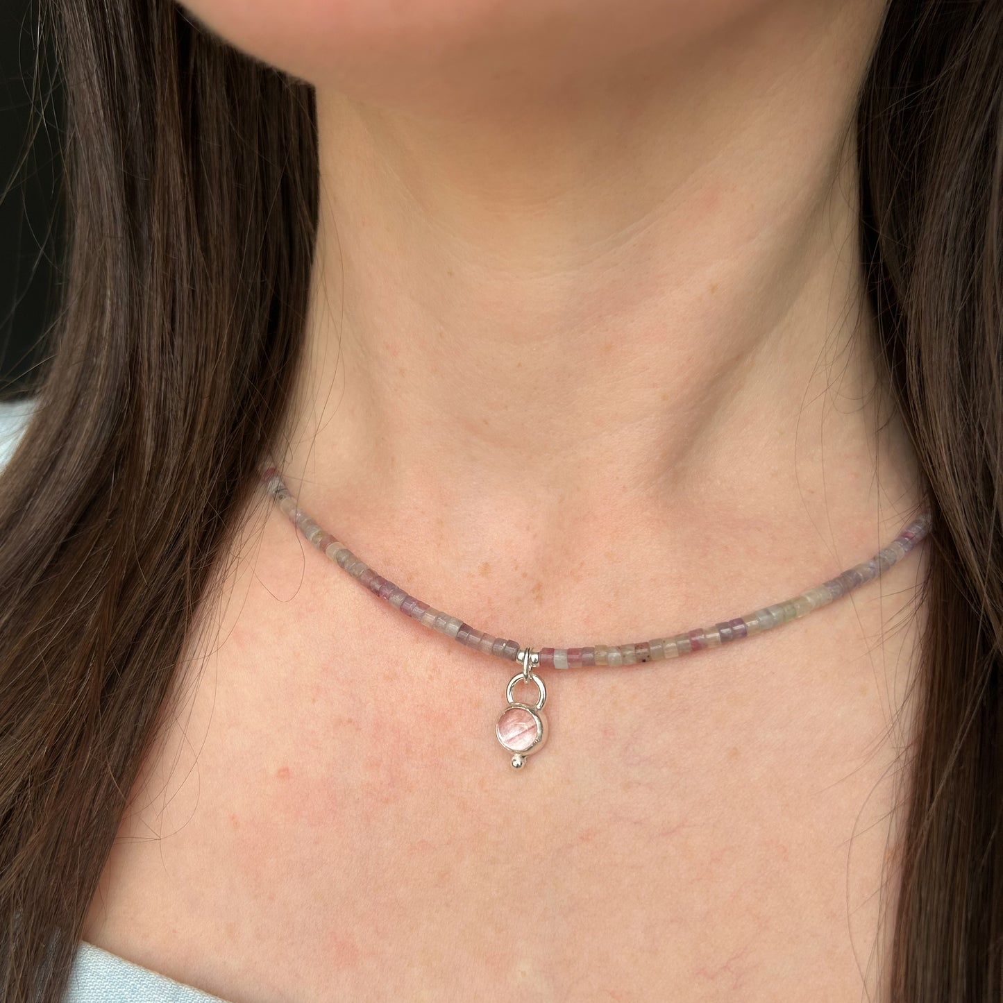Pink necklace on models chest