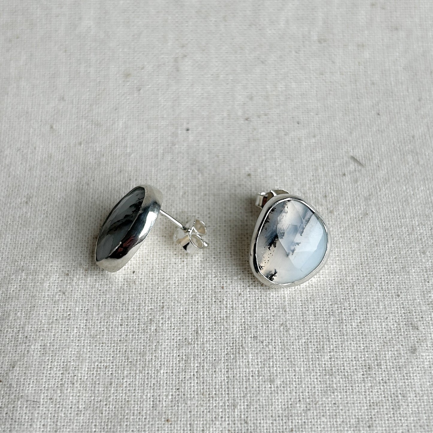 Silver earrings featuring milky opal gemstones 
