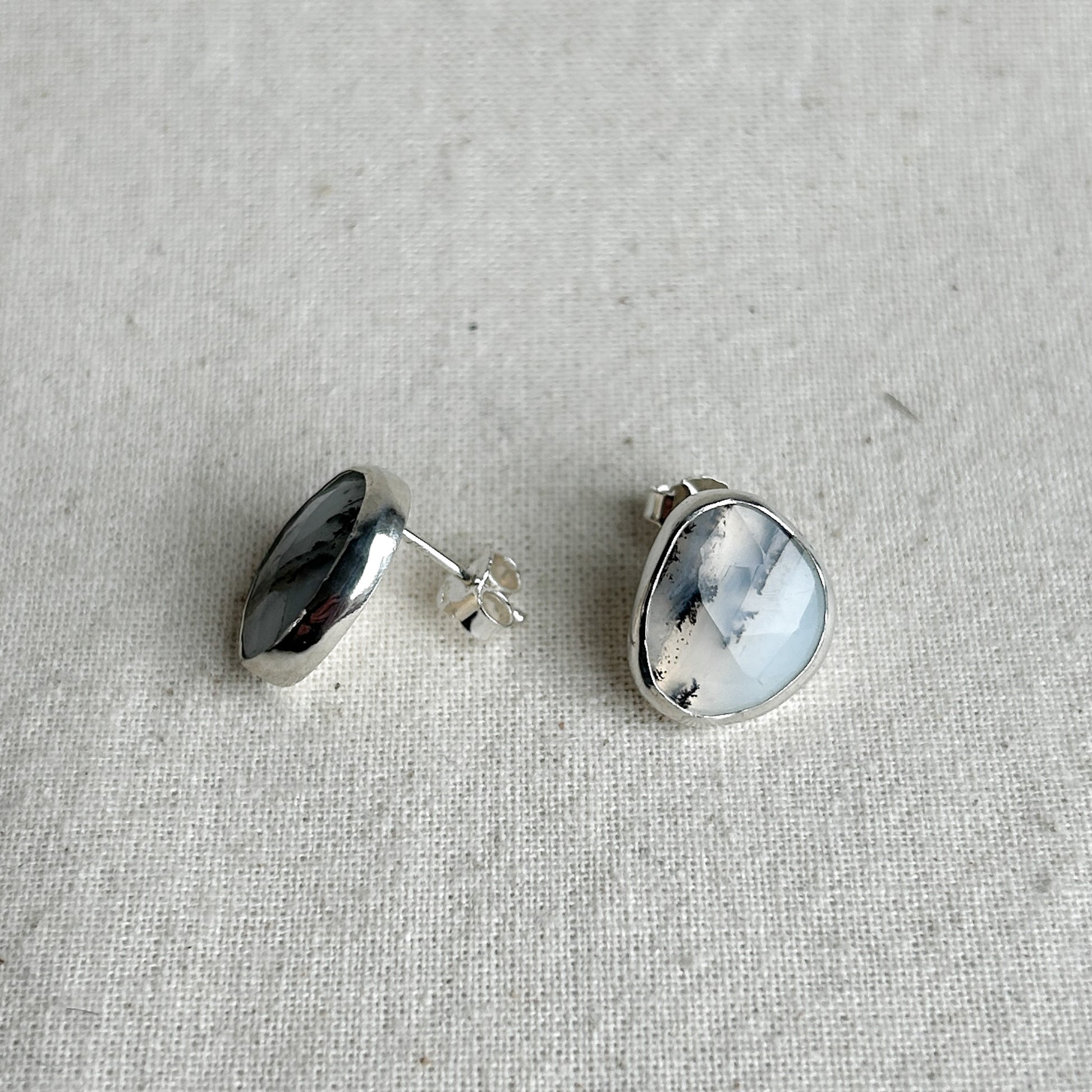 Silver earrings featuring milky opal gemstones 