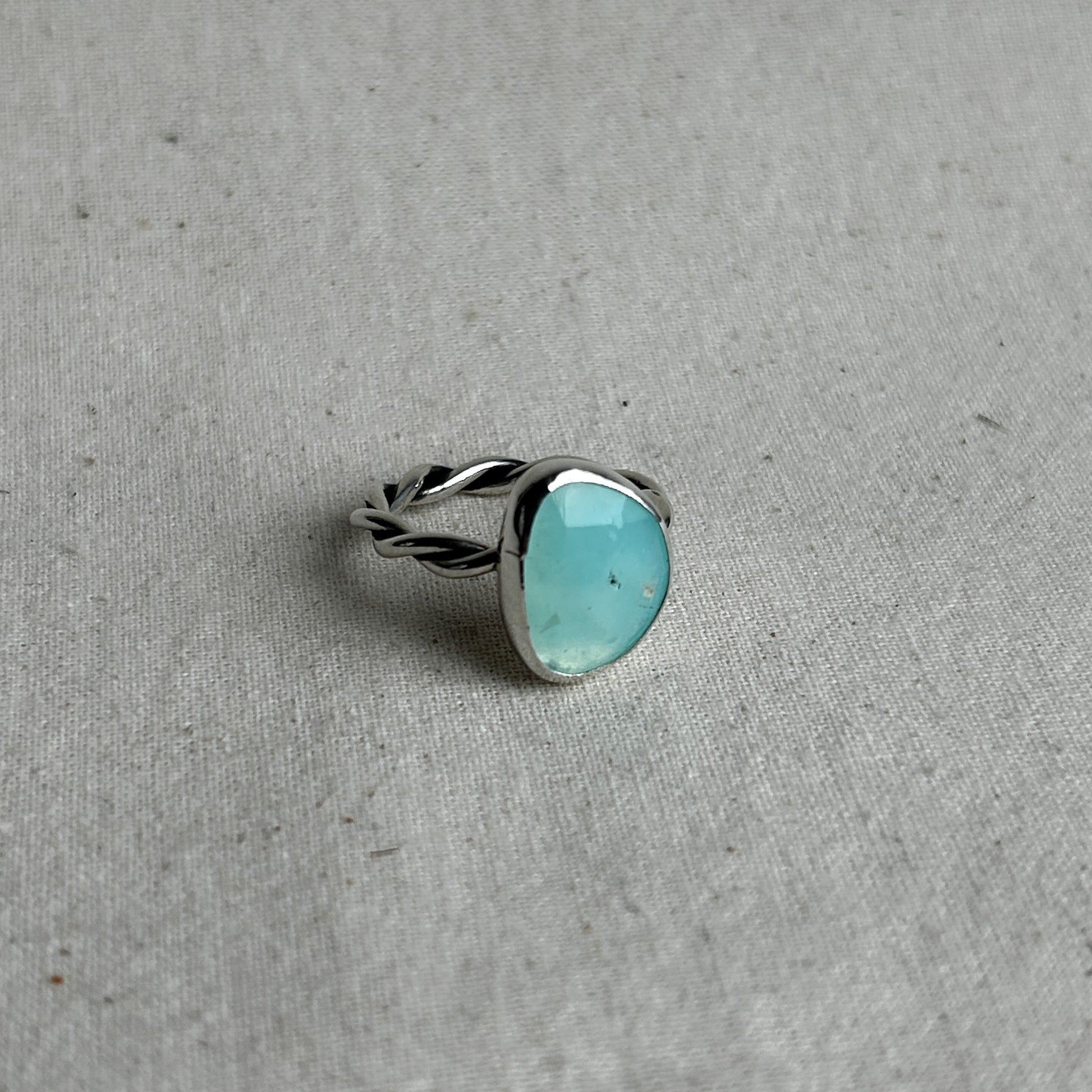 Pale blue Opal ring on linen background