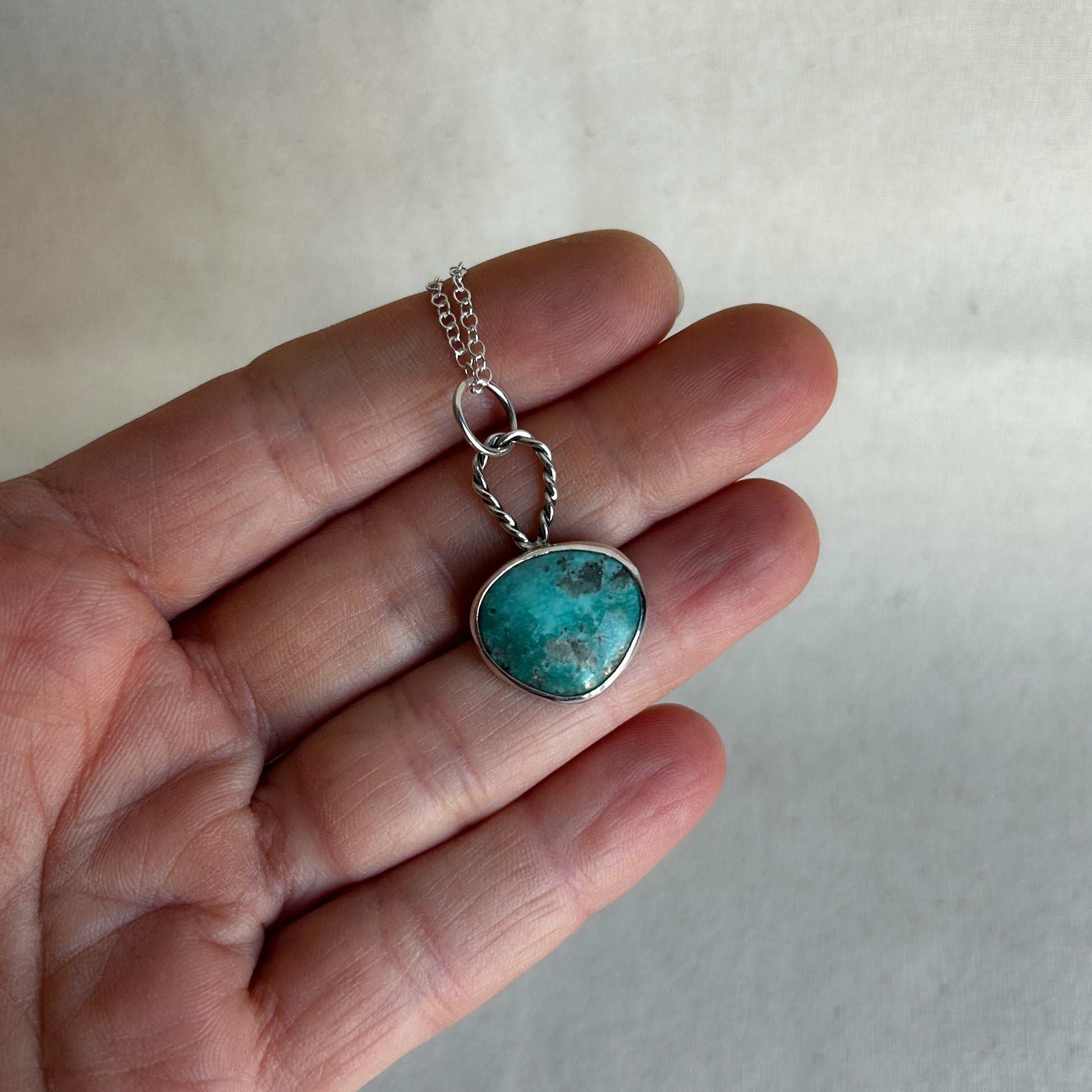 Small turquoise pendant with green gemstone and silver chain 