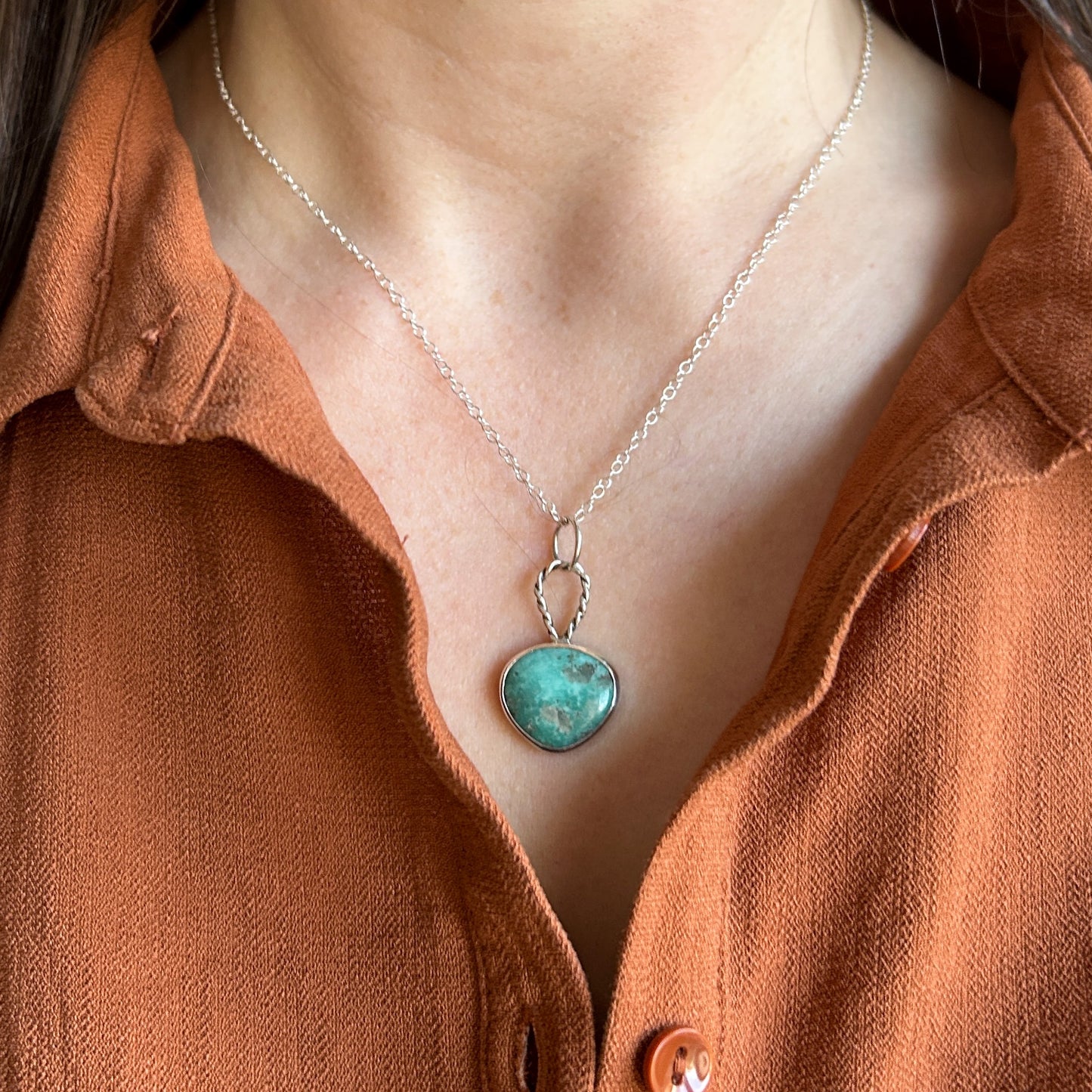 Green turquoise pendant with silver chain on model 