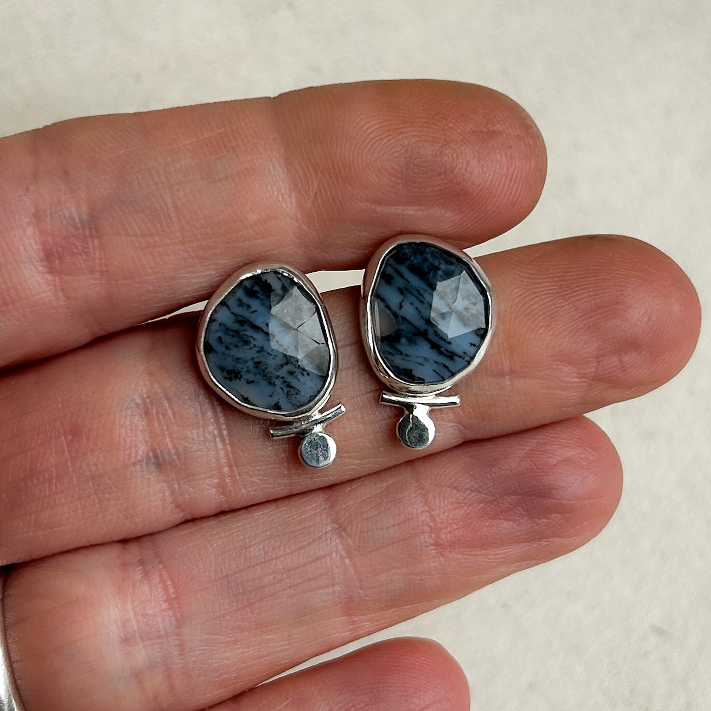 Opal stud earrings with small silver accents 