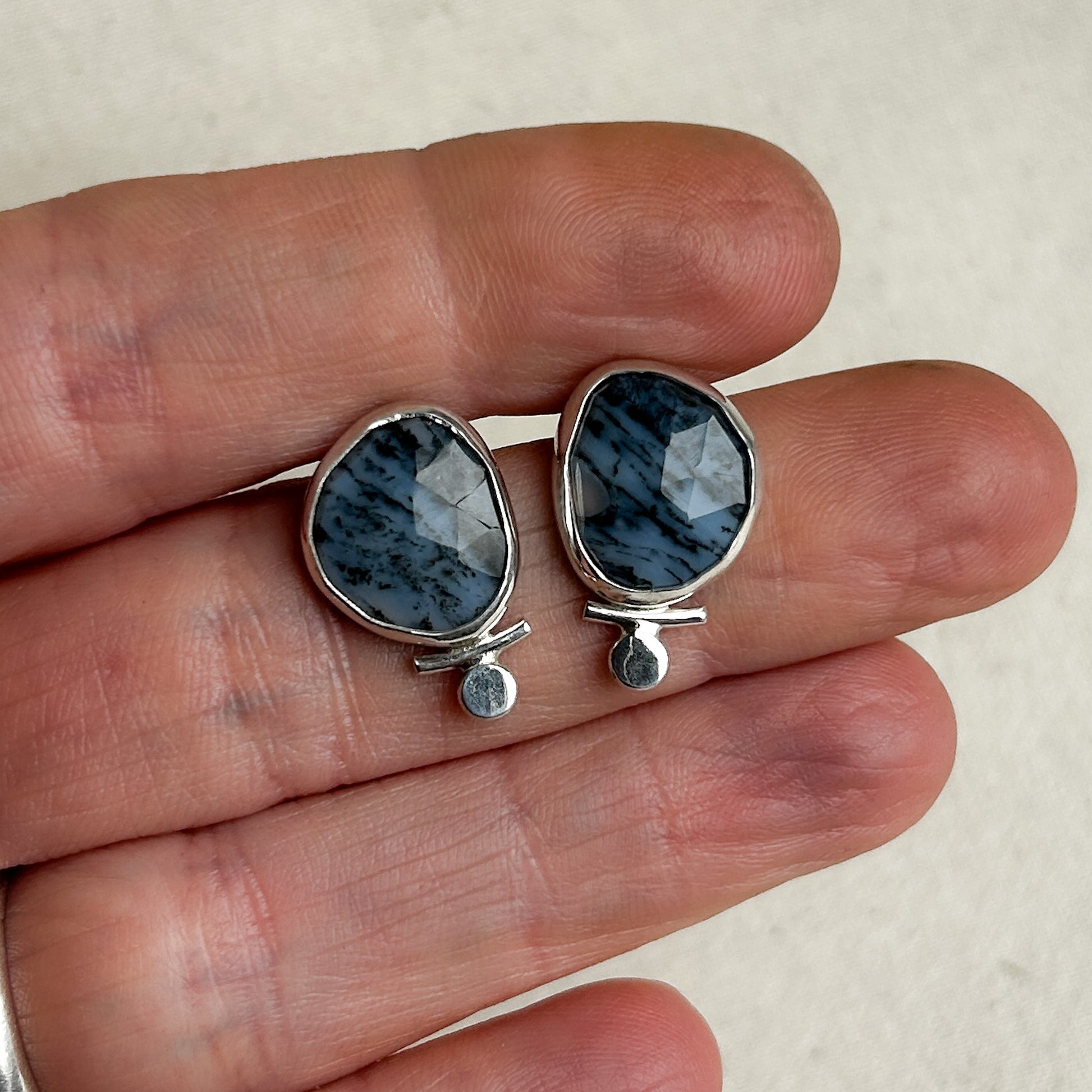 Opal stud earrings with small silver accents 