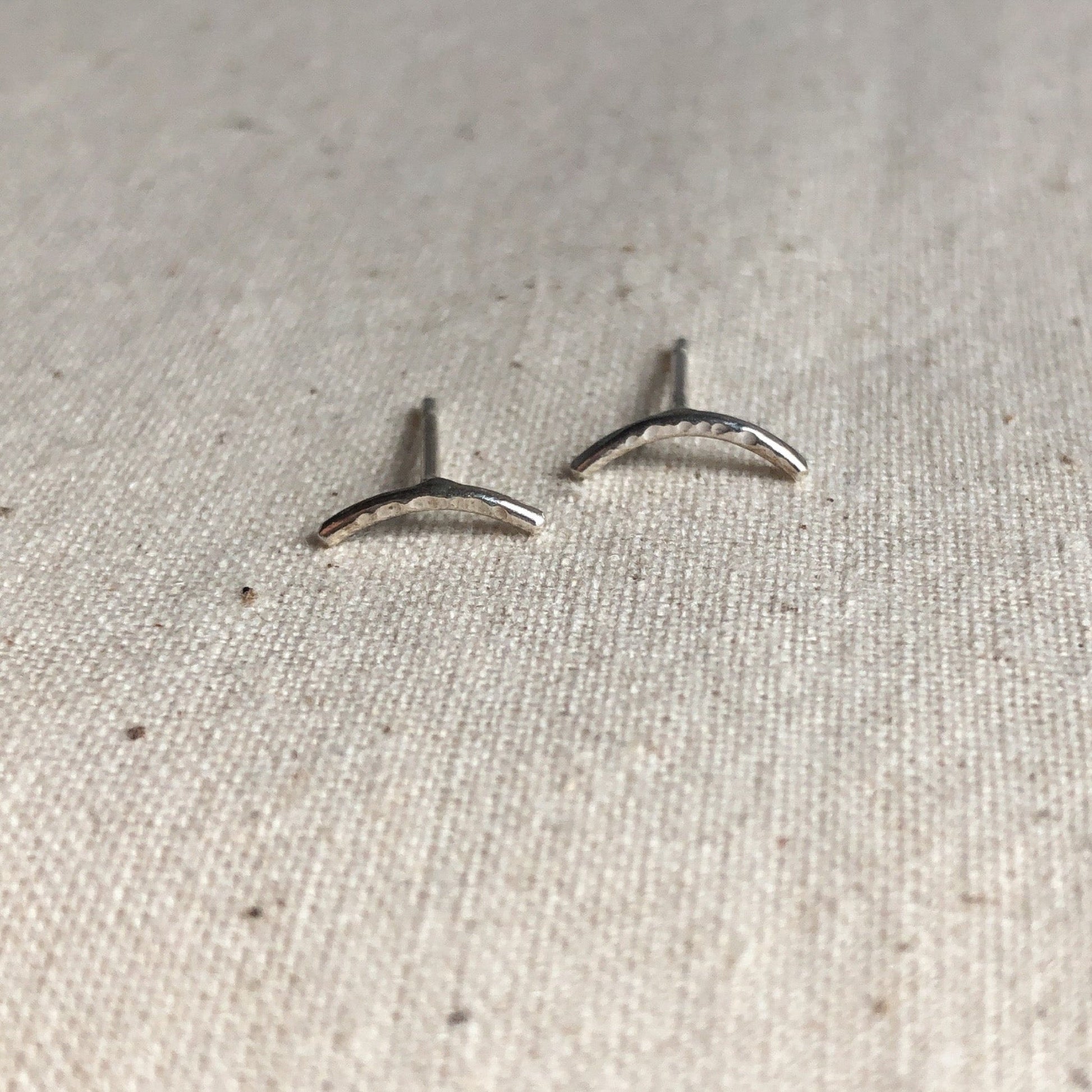 Shimmer sterling silver bar stud earrings on grey background. 