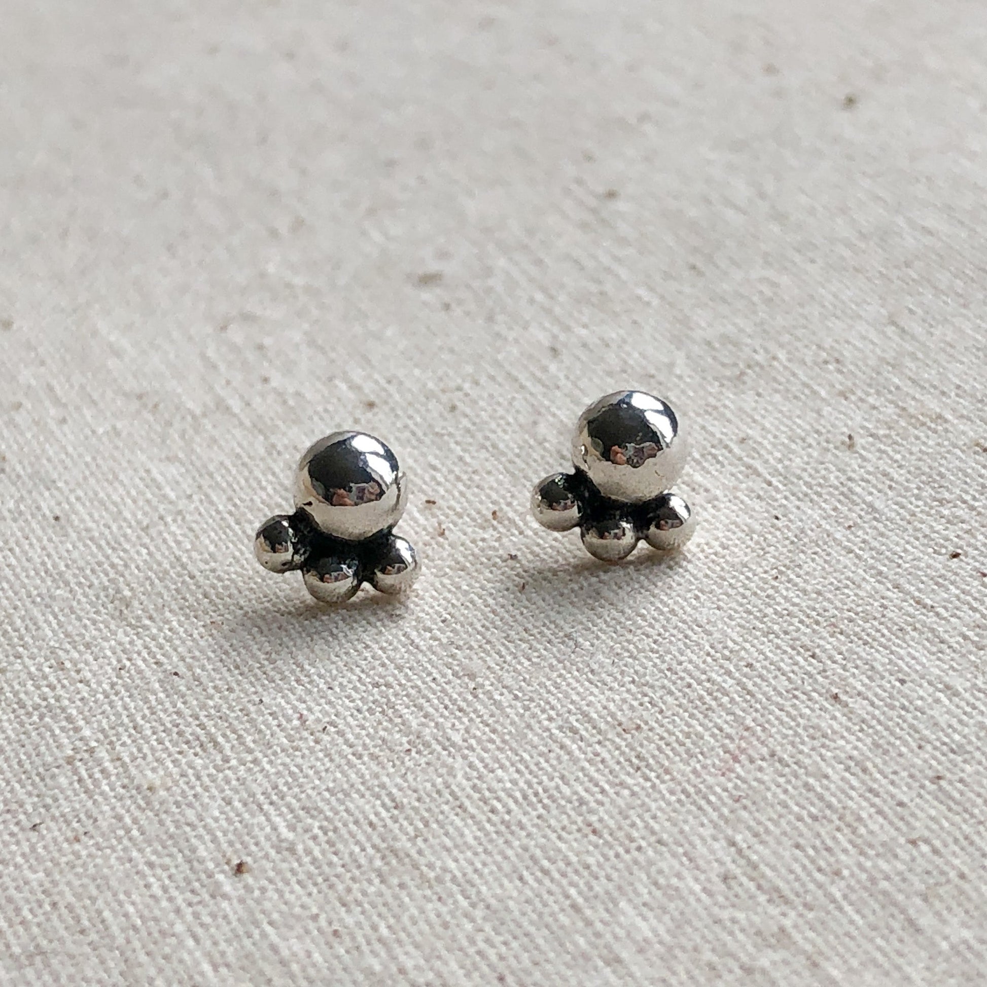 Stud Earrings made of Argentium silver on grey background.